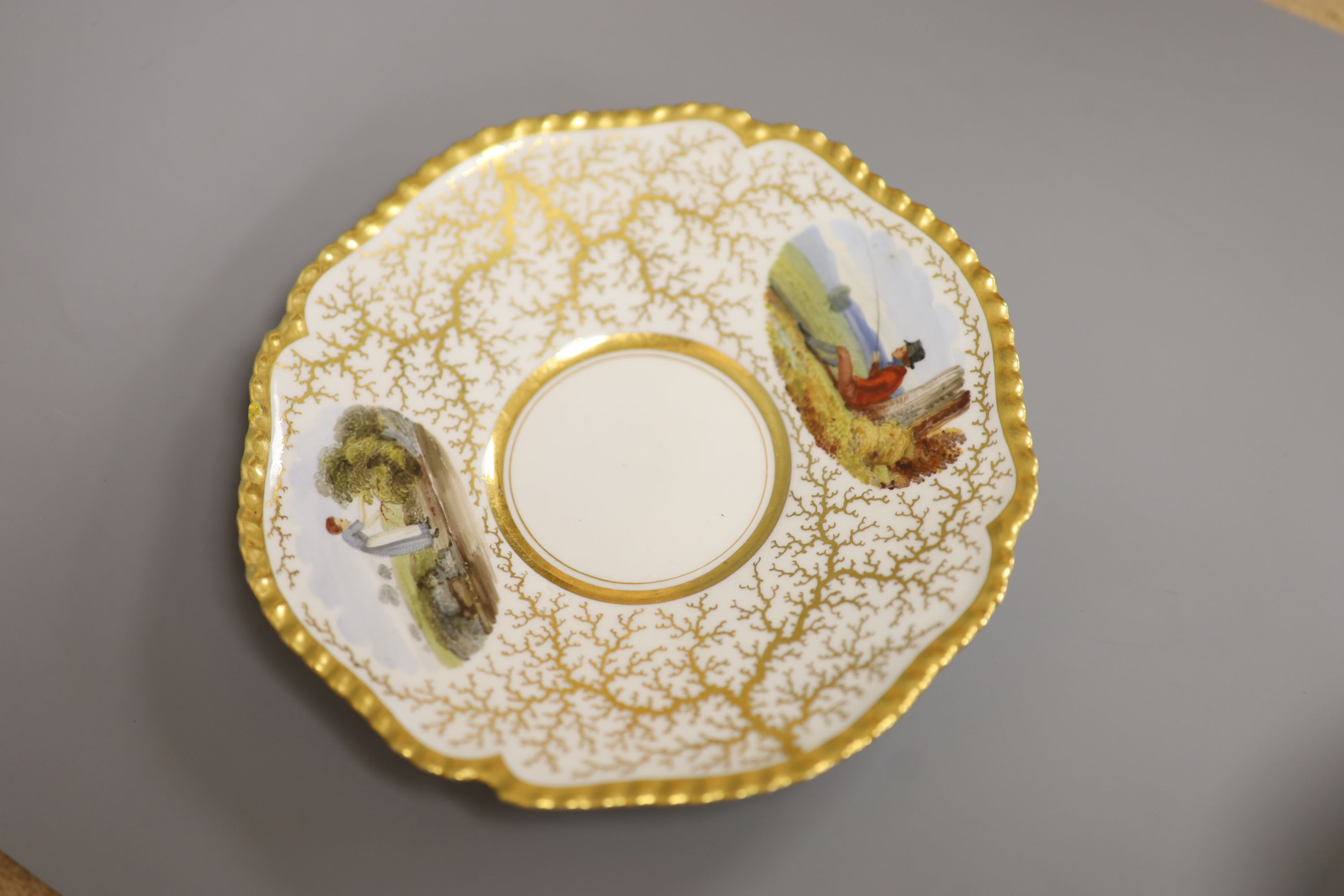 A Flight Barr & Barr cup and saucer, painted with Binstead cottage, Isle of White and Land Gate, Winchelsea, the saucer with country folk diameter 15cm